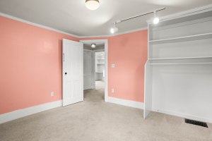 Carpeted bedroom with built-in shelving at 52 North Lyon Street