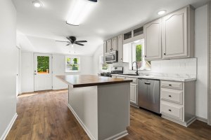 Bright updated kitchen with a large wood-topped island at 52 North Lyon Street in Batavia, New York