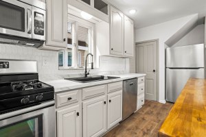 Bright kitchen with white cabinetry and stainless-steel appliances at 52 North Lyon Street