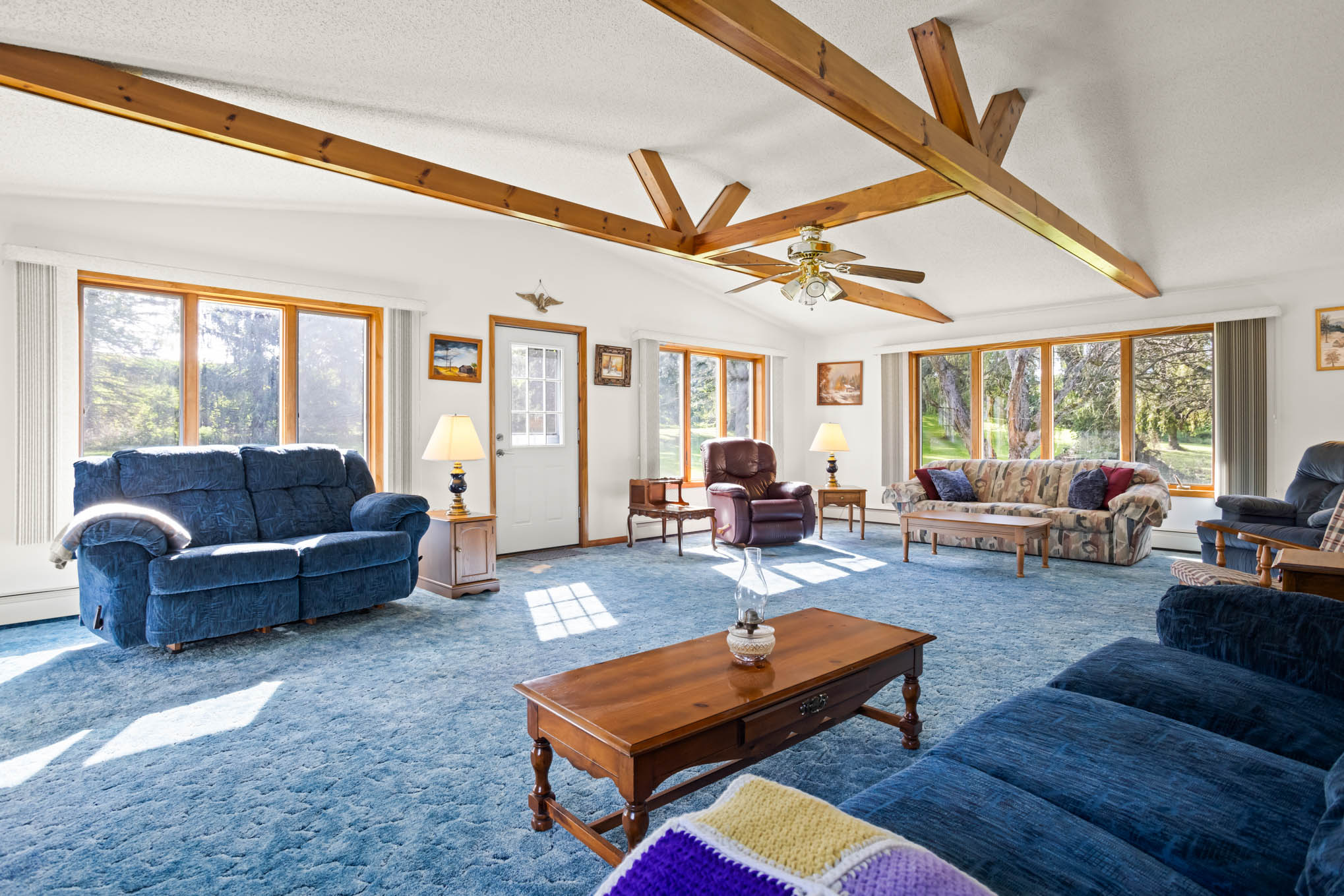 Great room with natural wood beams and abundant natural light