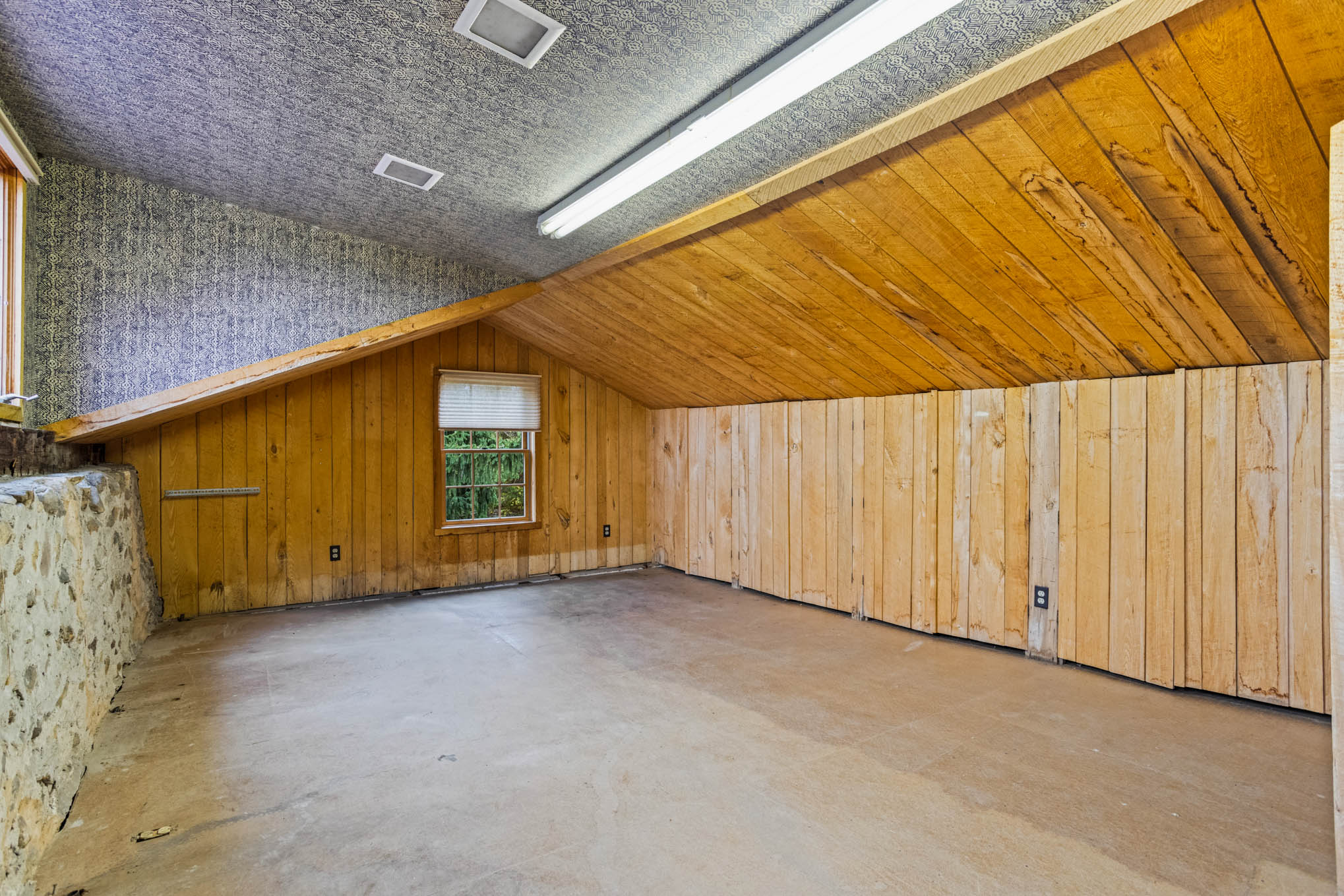 Upper loft with wood paneling