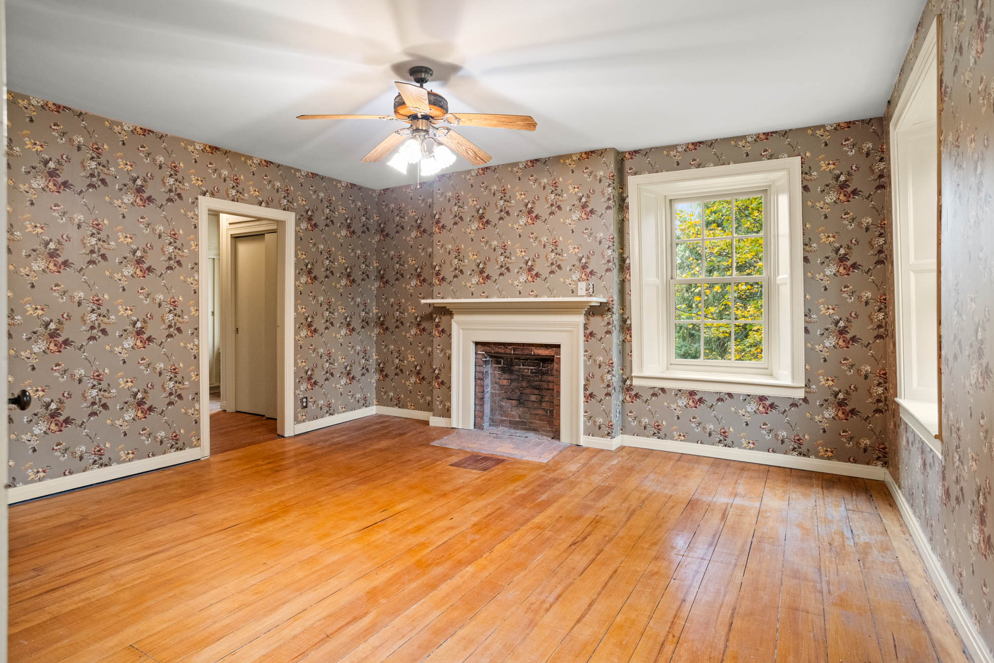 Bedroom with wood floors and fireplace