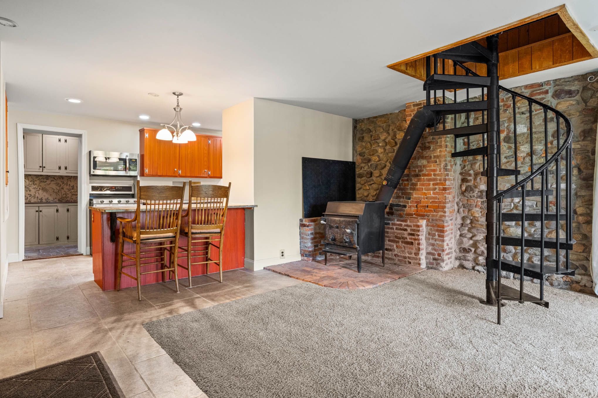 Spiral staircase beside kitchen breakfast bar