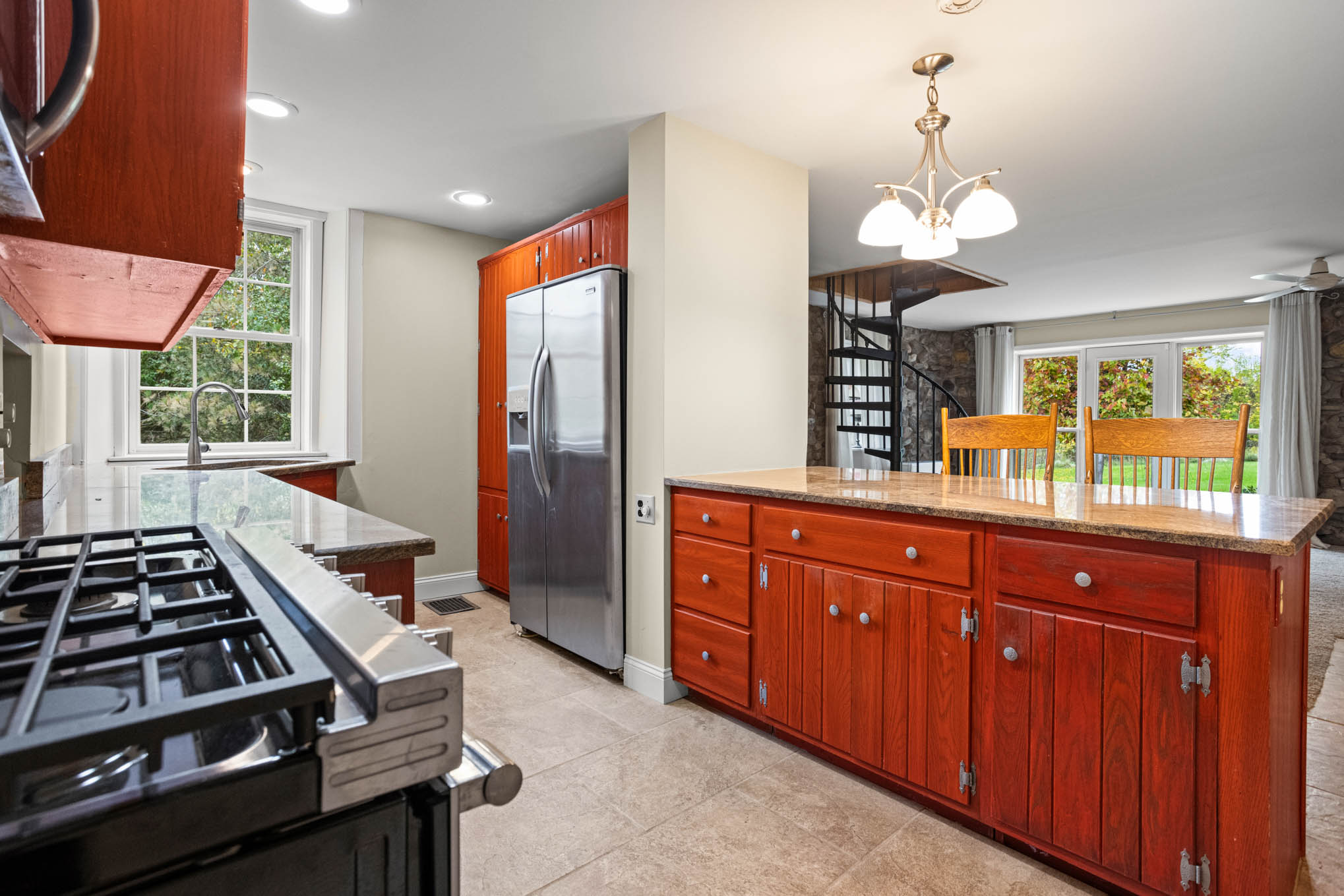 Kitchen overlooking stone family room